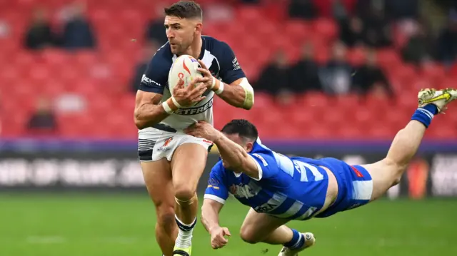 Tommy Makinson carries the ball for England