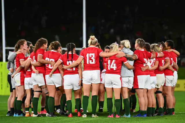 Wales players talk in a huddle after the match