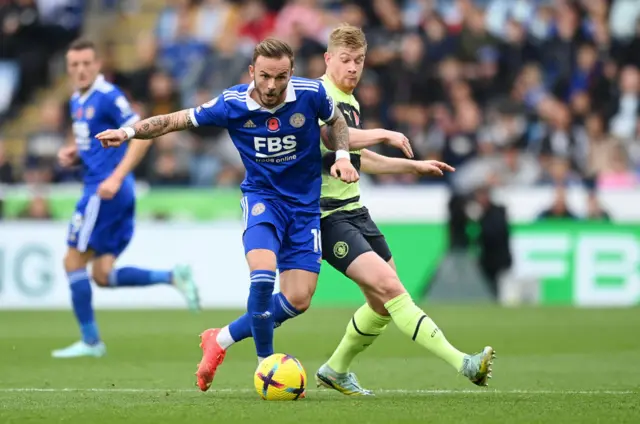 Kevin De Bruyne battles for possession with James Maddison