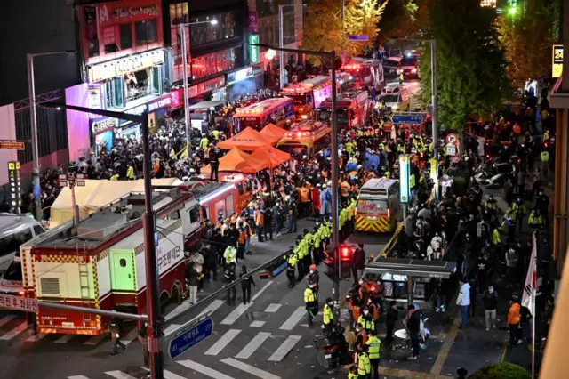 Ambulances, fire engines and first aid tents treating injured, 29 Oct 22