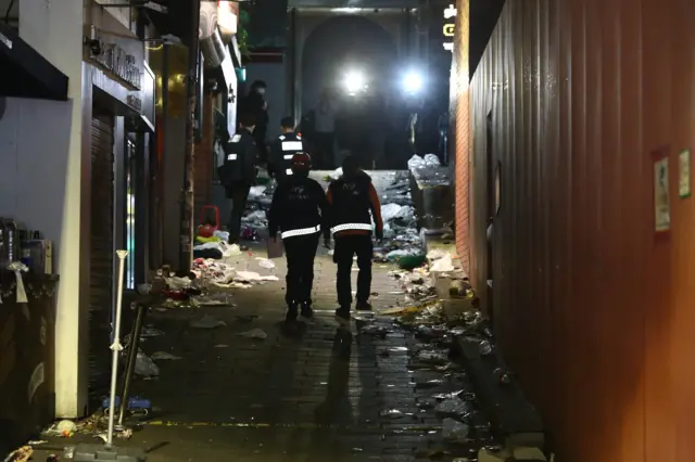 Emergency workers and police are investigating the cause of the crush in an alley