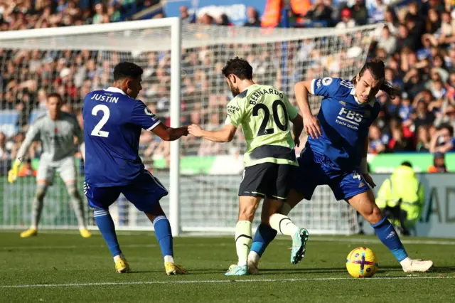 Caglar Soyuncu tackles Bernardo Silva of Manchester