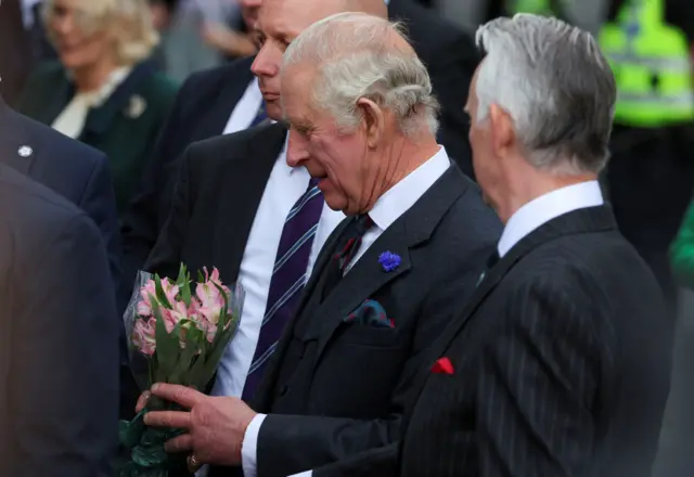 King Charles is given flowers as he greets crowds in Dunfermline