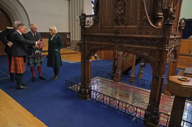 King Charles III and the Queen Consort are shown the grave stone of Robert the Bruce