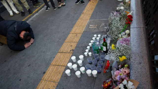 A man bows as he mourns those killed in the stampede in Seoul