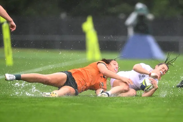 Helena Rowland of England is tackled by Bienne Terita of Australia