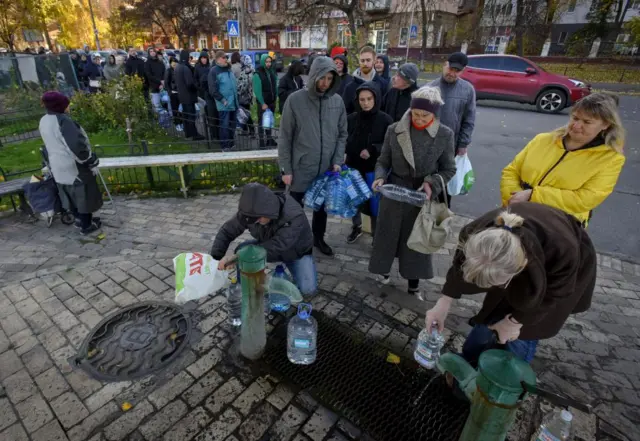 People take water from a water pump in Kyiv