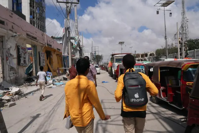 People walked close to the site of the bomb in Mogadishu.