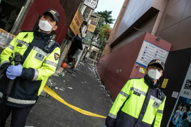 Police stand guard at the accident site in Itaewon in Seoul