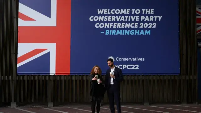 People take a selfie during Britain's Conservative Party's annual conference in Birmingham