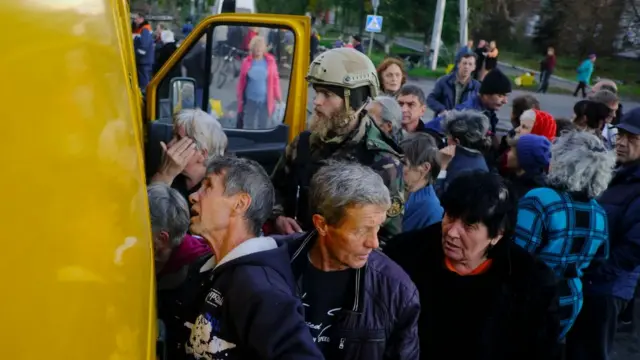 People receive humanitarian aid from a self-organized volunteer group, in the recently recaptured city of Lyman, Donetsk area, eastern Ukraine, 04 October 2022 (issued 05 October 2022), amid Russia's invasion. The Ukrainian army pushed Russian troops from occupied territory in the northeast of the country in a counterattack