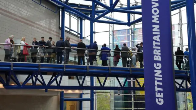 Tory delegates form a line across a bridge in Birmingham's International Conference Centre