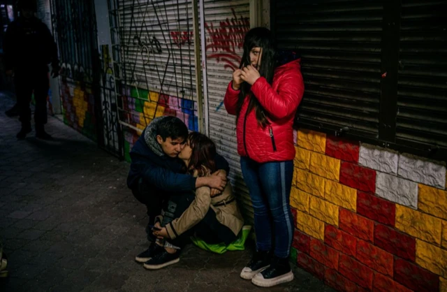 Young people hide during an air raid in Zaporizhzhia