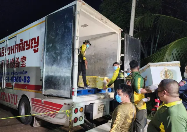 Rescue workers carry the coffin of one of the victims of the attack in Nong Bua Lamphu province