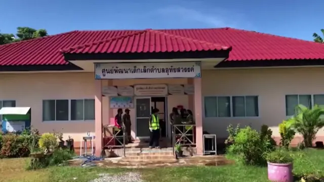 Picture shows front of nursery, with police investigators standing outside