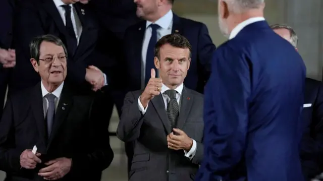 France's President Emmanuel Macron, center, gives Albania's Prime Minister Edi Rama a thumbs up