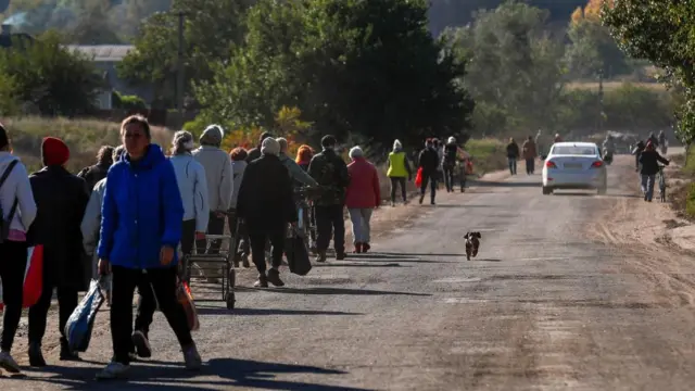 Residents of Kapytolyvka return to their homes after a truck carrying humanitarian aid truck was unable to arrive, east of Izyum, Kharkiv Oblast, Ukraine, 06 October 2022.