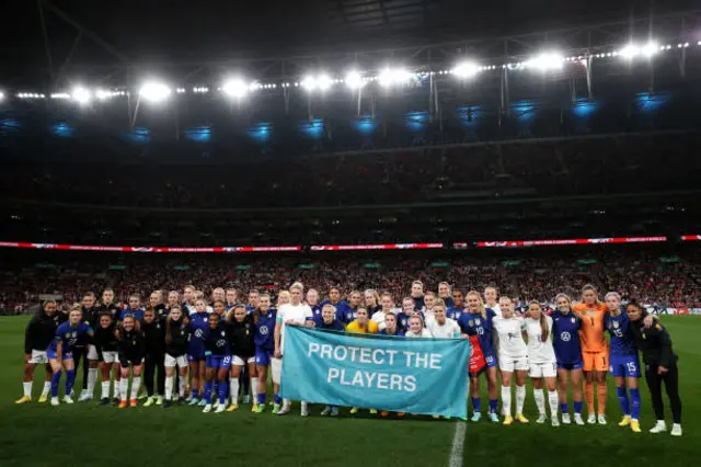 Players holding up banner