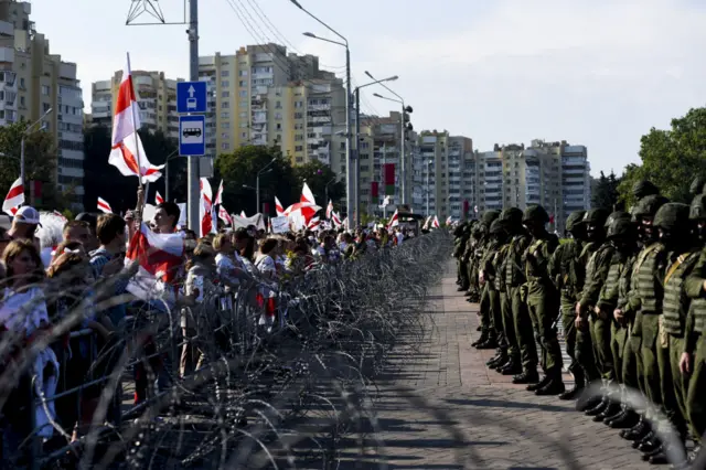 Security forces stand guard as people protest in Minsk, Belarus in August 2020