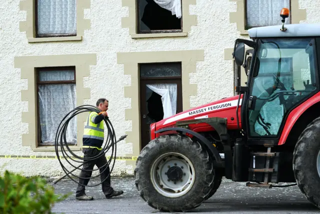 A man walks past a police cordon near the scene of the explosion in Creeslough