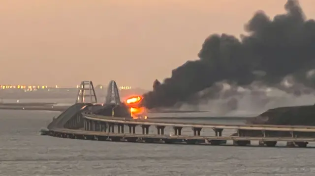 A fire on the Kerch bridge at sunrise in the Kerch Strait, Crimea