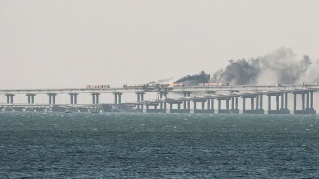 Fuel tanks ablaze and damaged sections of the Kerch bridge in the Kerch Strait, Crimea