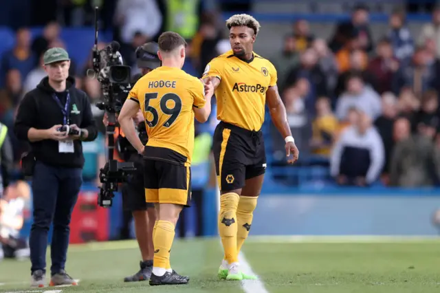 Premier League debutant Joe Hodge of Wolverhampton Wanderers shakes hands with Adama Traore