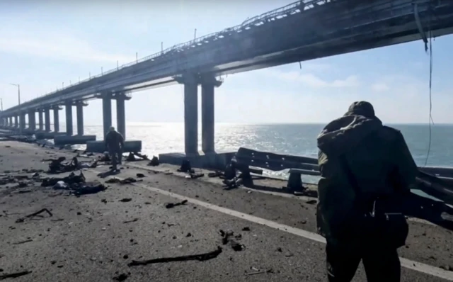 Russian investigators work on a collapsed part of Crimean bridge