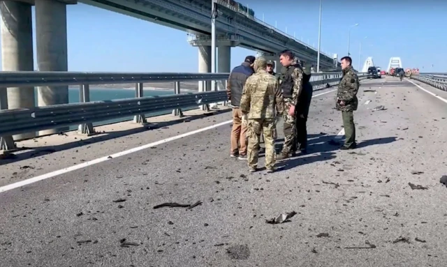 Russian investigators work on a collapsed part of Crimean bridge