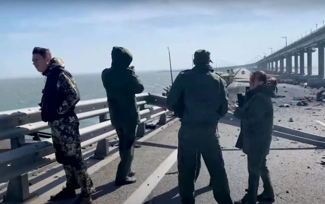 Russian investigators work on a collapsed part of Crimean bridge