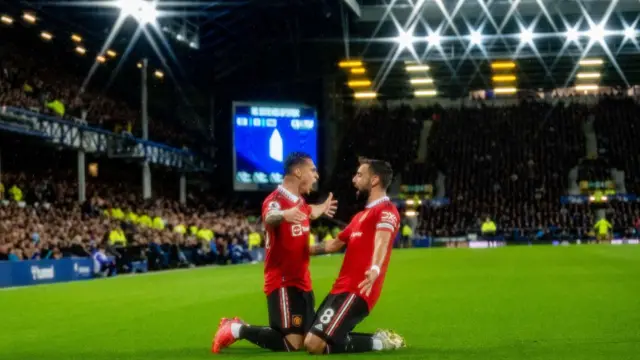 Antony celebrates scoring his first goal with Bruno Fernandes.