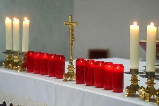 10 red candles lit in St Michael's Church