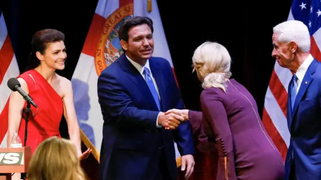 Republican Florida Governor Ron DeSantis shakes hands with Chelsea Grimes, fiance of Democratic challenger Charlie Crist, after debating with Crist ahead of midterm elections, in Fort Pierce, Florida, U.S., October 24, 2022