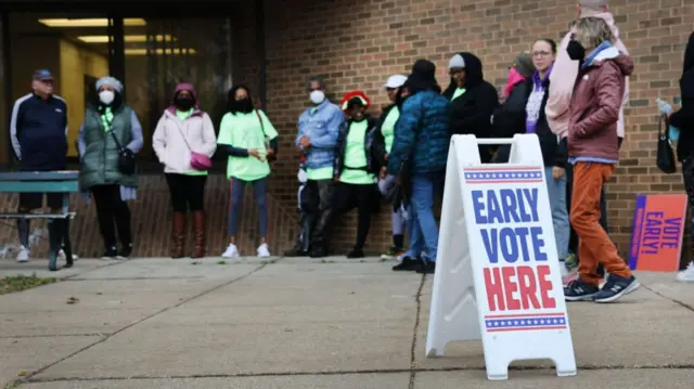 People wait in line outside a polling place at the start of early voting on October 25, 2022 in Milwaukee, Wisconsin. Early voting for the mid-term election begins today in Wisconsin.