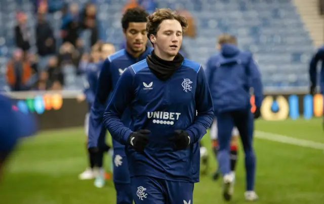 Alex Lowry going through his paces pre-match at Ibrox