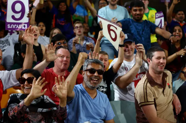 New Zealand fans celebrate a six