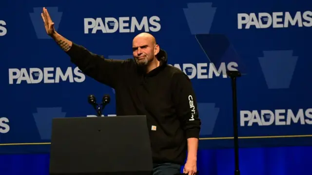 : Democratic candidate for Senator Jon Fetterman waves to supporters while taking the stage during the Democratic Party's Independence Dinner with a keynote address by President Joe Biden and Vice President Kamala Harris on October 28, 2022 in Philadelphia, Pennsylvania