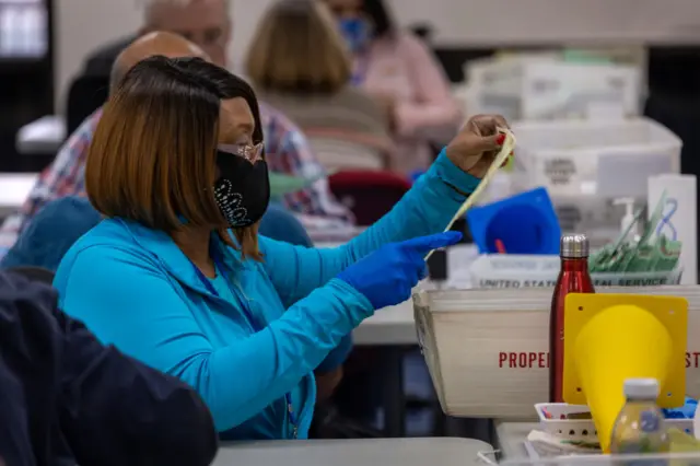 An election worker sort through ballots