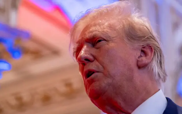 Former US President Donald Trump talks to the press on the grounds of his Mar-a-Lago resort on midterm elections night in Palm Beach, Florida