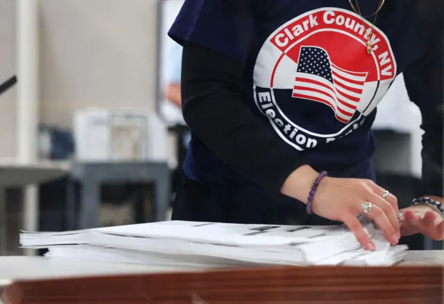 Poll worker handling ballots in Clark County, Nevada.