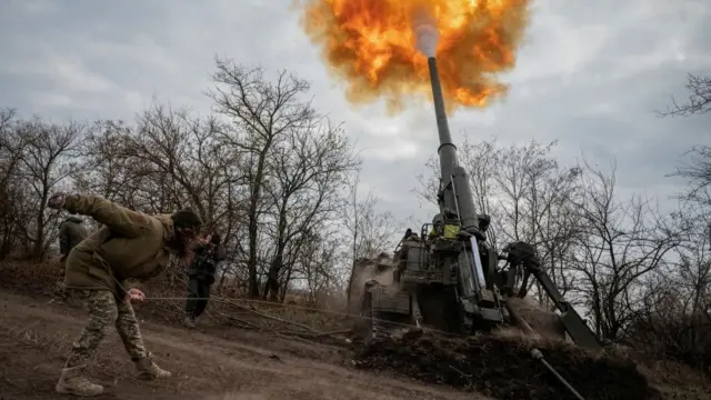 A Ukrainian servicewoman fires a 2S7 Pion self-propelled gun at a position, as Russia's attack on Ukraine continues, on a frontline in Kherson region, Ukraine November 9, 2022.