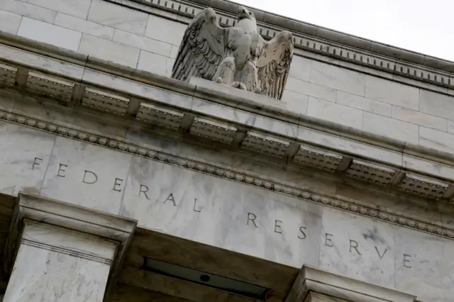 An eagle sits atop the US Federal Reserve building's facade in Washington