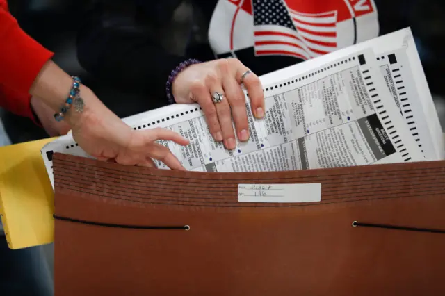 An election worker prepares ballots to be processed at the Clark County Election Department in North Las Vegas, Nevada