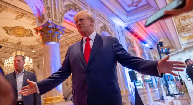 Former US President Donald Trump talks to the press on the grounds of his Mar-a-Lago resort on midterm elections night in Palm Beach, Florida