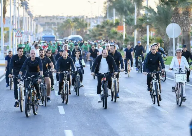 Egyptian President Abdel Fattah al-Sisi rides a bicycle as he takes a tour of the Green Zone during the COP27 climate summit, in Sharm el-Sheikh, Egypt, November 10