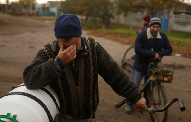 Vadym Slobodianiuk, 48, reacts as he speaks about death of his parents in Blahodatne