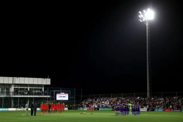 Players from both England and Japan mark Remembrance Day with a moment of silence.