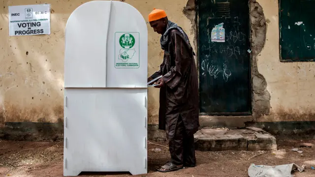 A man prepares to submit his ballot for the 2019 Nigerian presidential elections