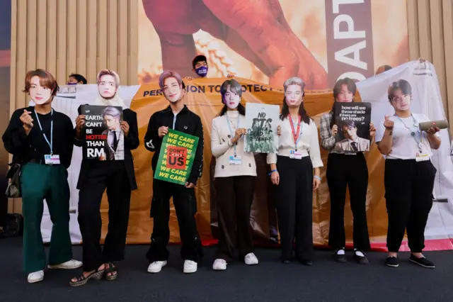 Climate activists of the BTS army protest against climate change at the Sharm El-Sheikh International Convention Centre, during the COP27 climate summit, in Sharm el-Sheikh, Egypt, November 10, 2022.