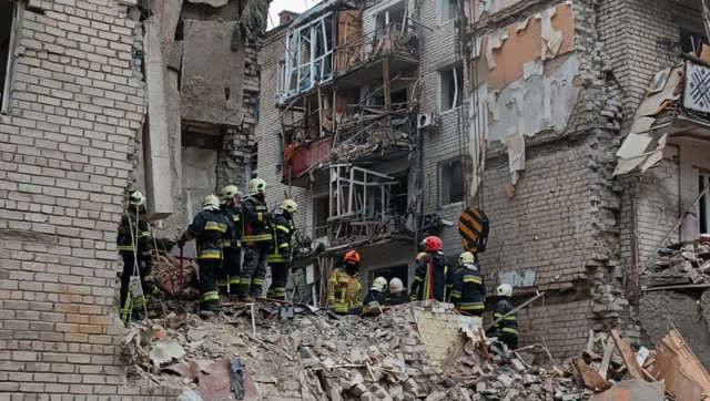 Rescuers work at a site of a residential building heavily damaged by a Russian missile attack, as Russia's attack on Ukraine continues, in Mykolaiv